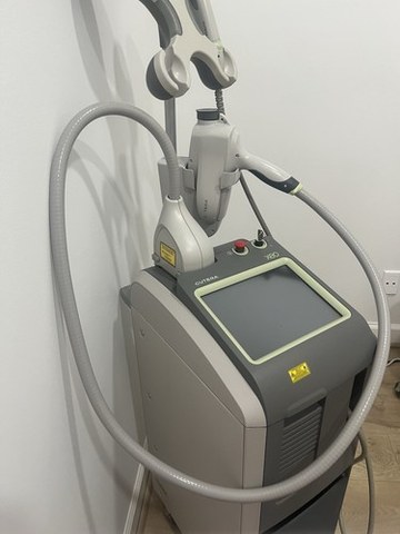 Cutera Xeo system photographed in a treatment room with its handpieces attached.